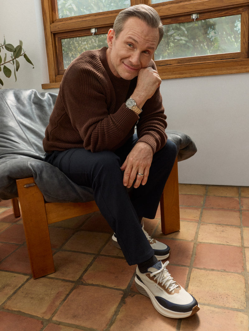 Man wearing blue and white sneakers