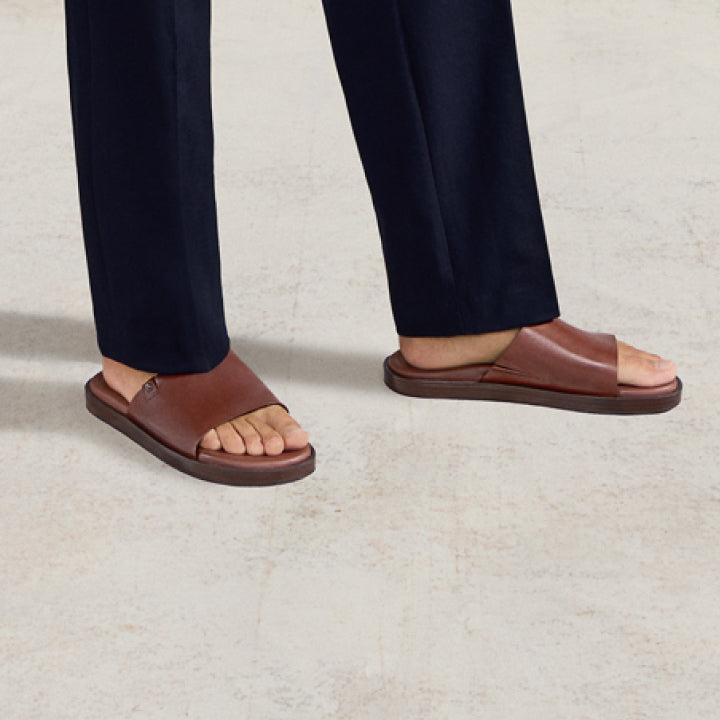 Man wearing brown sandals