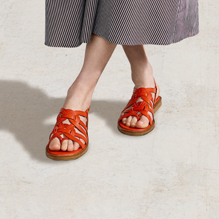 Woman wearing orange sandals