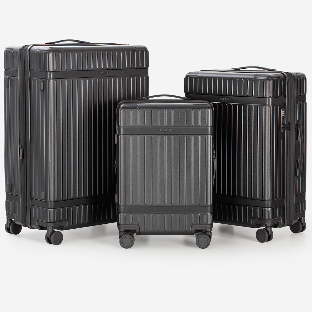 Three black suitcases of different sizes on a white background