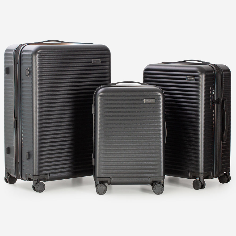 Three black suitcases of different sizes on a white background
