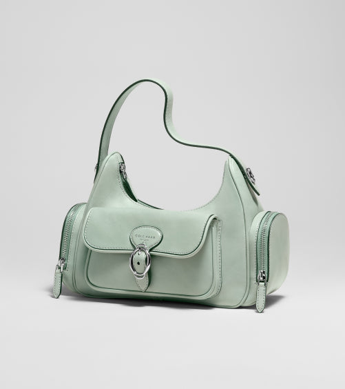 Light green handbag with a visible brand logo on a light gray background