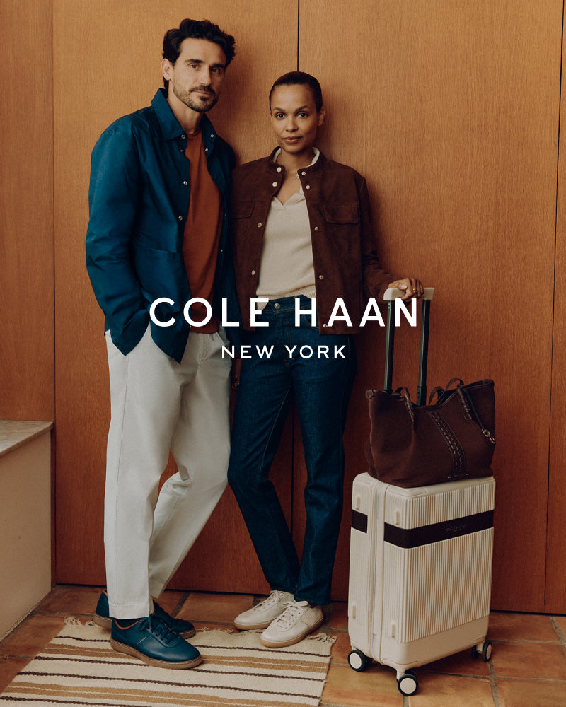 Two people standing next to luggage