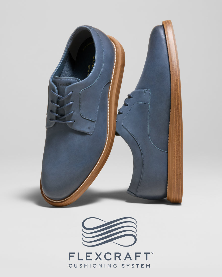 Blue shoes with brown soles on a light gray background, featuring the Flexcraft cushioning system logo.