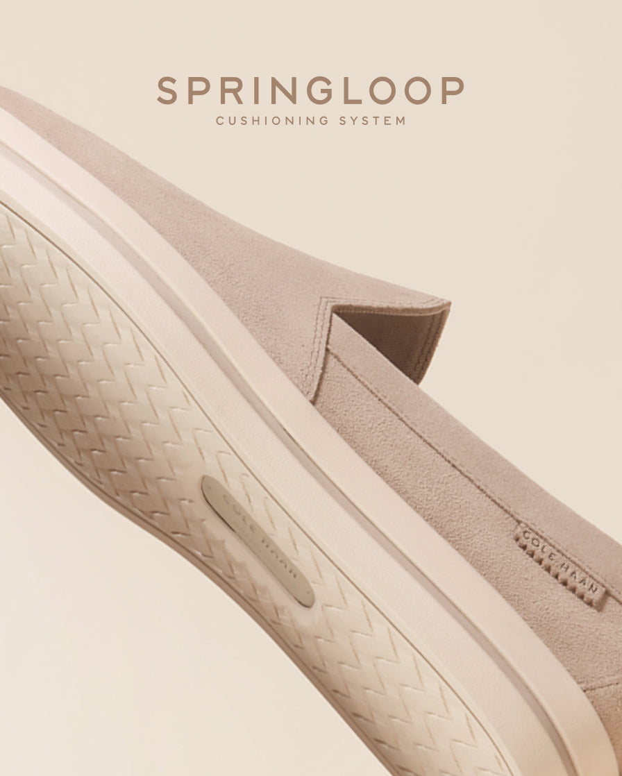 Close-up of a shoe with 'Springloop' cushioning system on a beige background