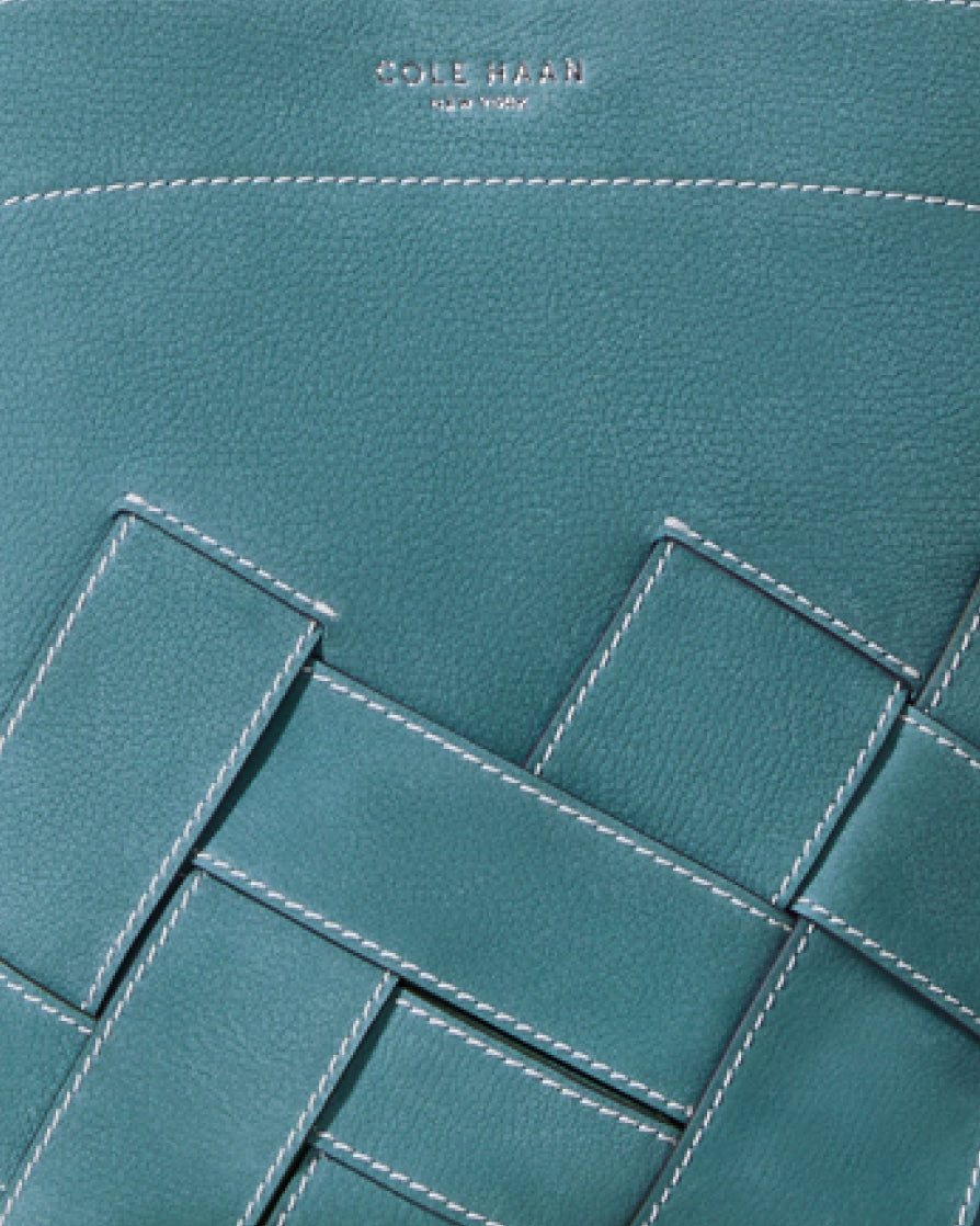 Teal leather bag with geometric stitching pattern, Cole Haan branding visible.
