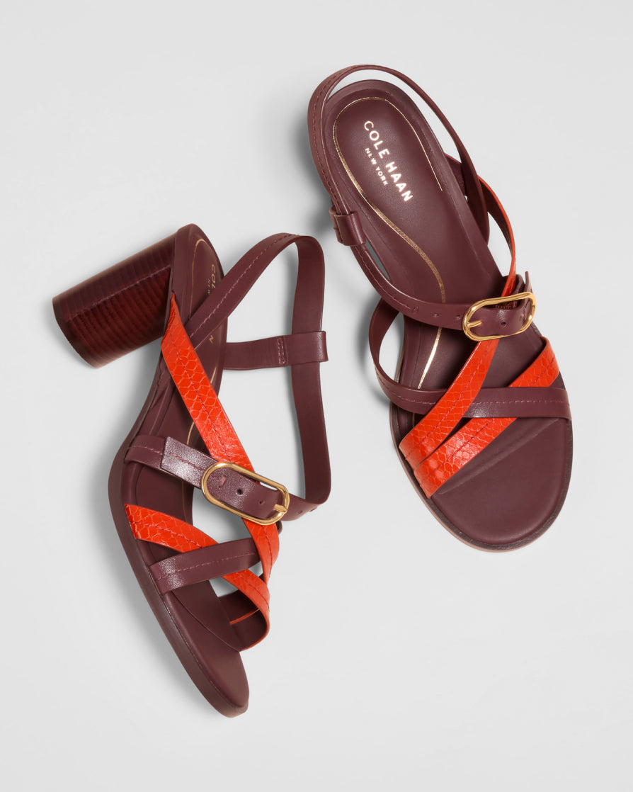 Brown and orange sandals with 'Cole Haan' branding on a light gray background