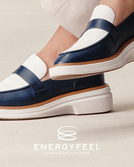 Navy and white loafers with a visible brand logo on a light background