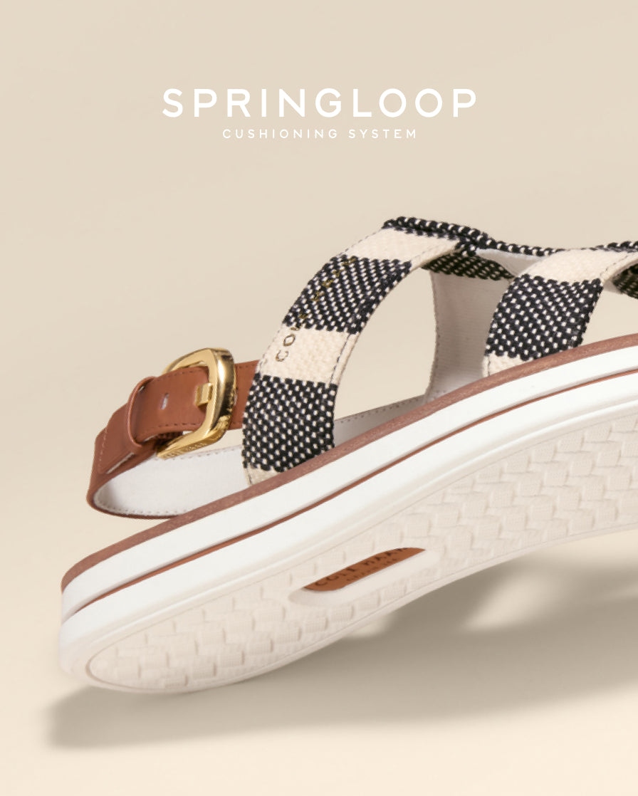Sandal with checkered strap and brown buckle on a beige background, featuring the Springloop cushioning system.