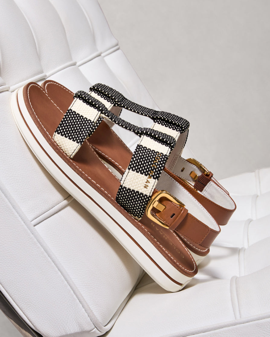Pair of sandals with decorative straps on a white surface