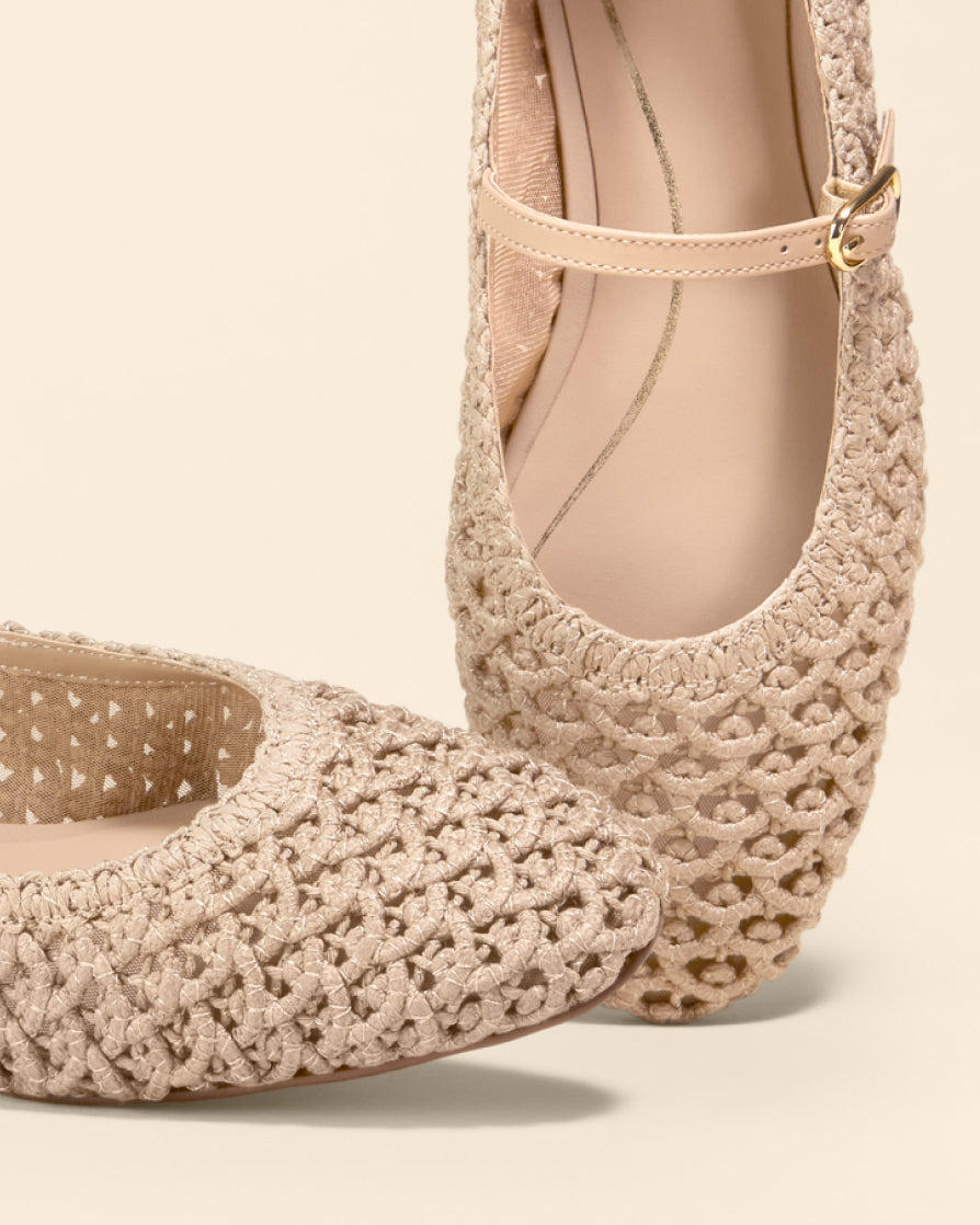 Beige woven shoes on a light beige background