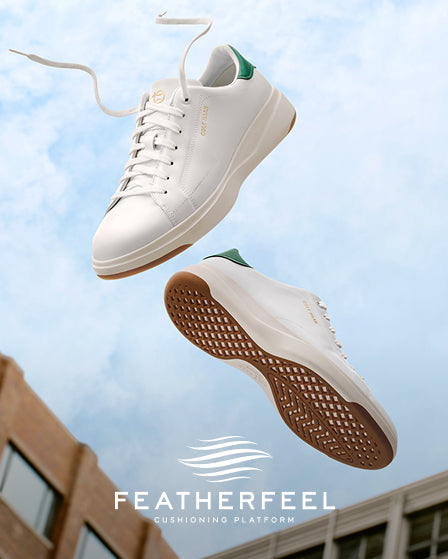 White sneakers with brown soles against a blue sky background, featuring the Featherfeel brand.