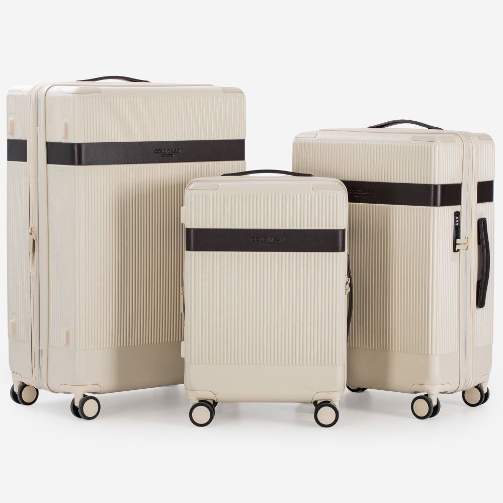 Three beige suitcases of different sizes with black straps on a white background
