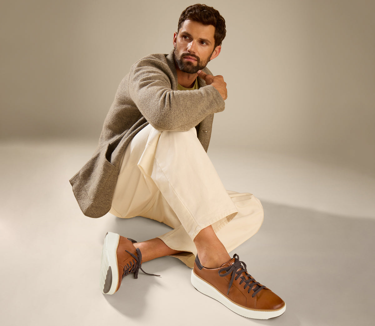 A man wearing brown topspin sneakers
