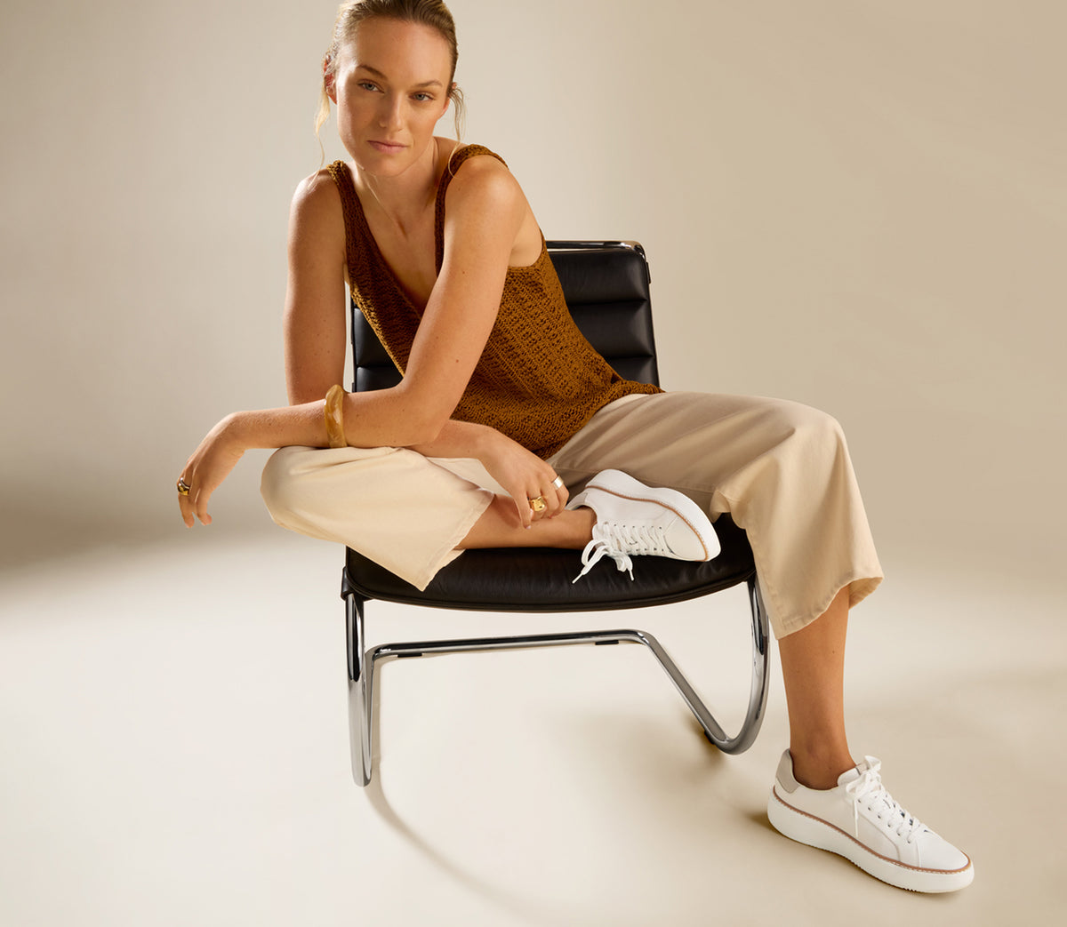 Woman wearing white topspin sneakers