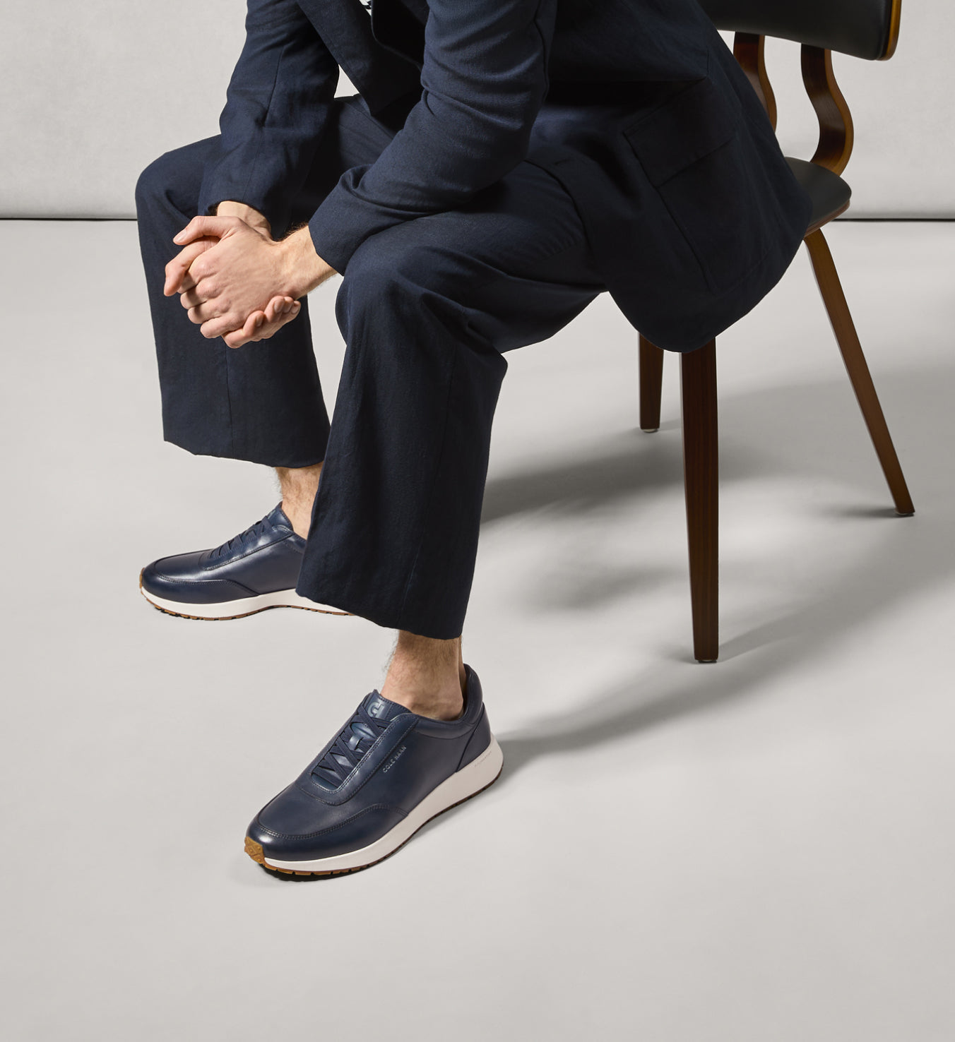 Man sitting wearing navy sneakers